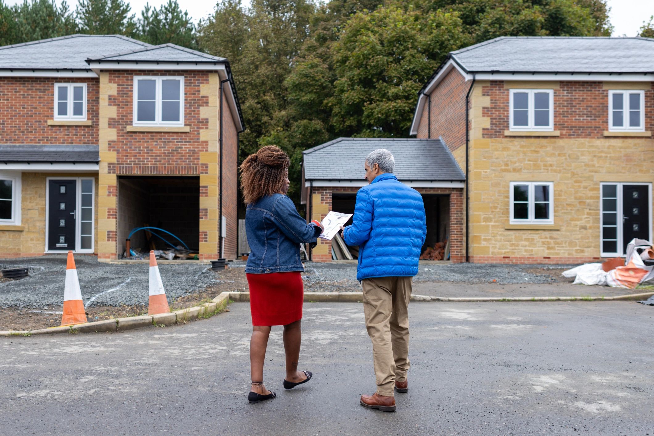 Property consultant discussing development plans at a housing site
